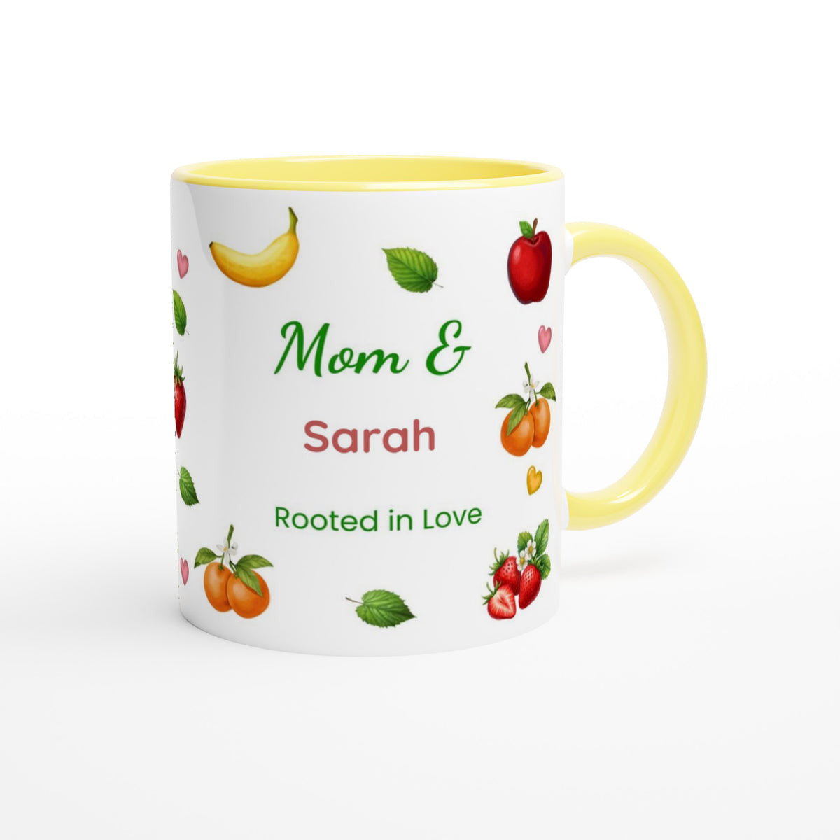 A white ceramic mug with a yellow interior and handle, decorated with illustrations of fruits and the personalized text 'Mom & Sarah Rooted in Love'.