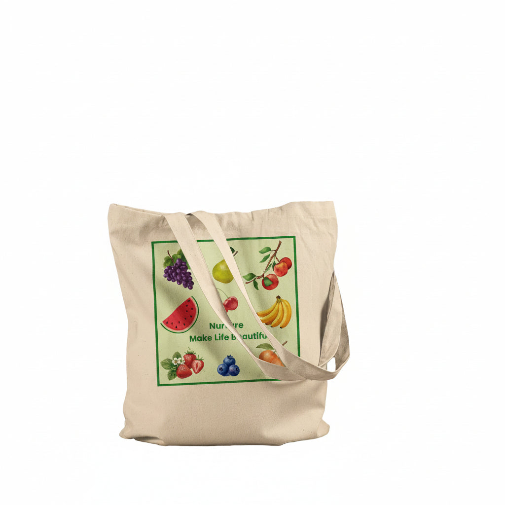 A natural beige canvas tote bag with a colorful fruit-themed graphic print on the front, featuring illustrations of watermelon, grapes, pear, strawberry, banana, and berries with the text 'Nur are Make Life beautiful'. The bag is shown against a plain white background.