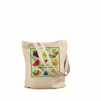 A natural beige canvas tote bag with a colorful fruit-themed graphic print on the front, featuring illustrations of watermelon, grapes, pear, strawberry, banana, and berries with the text 'Nur are Make Life beautiful'. The bag is shown against a plain white background.