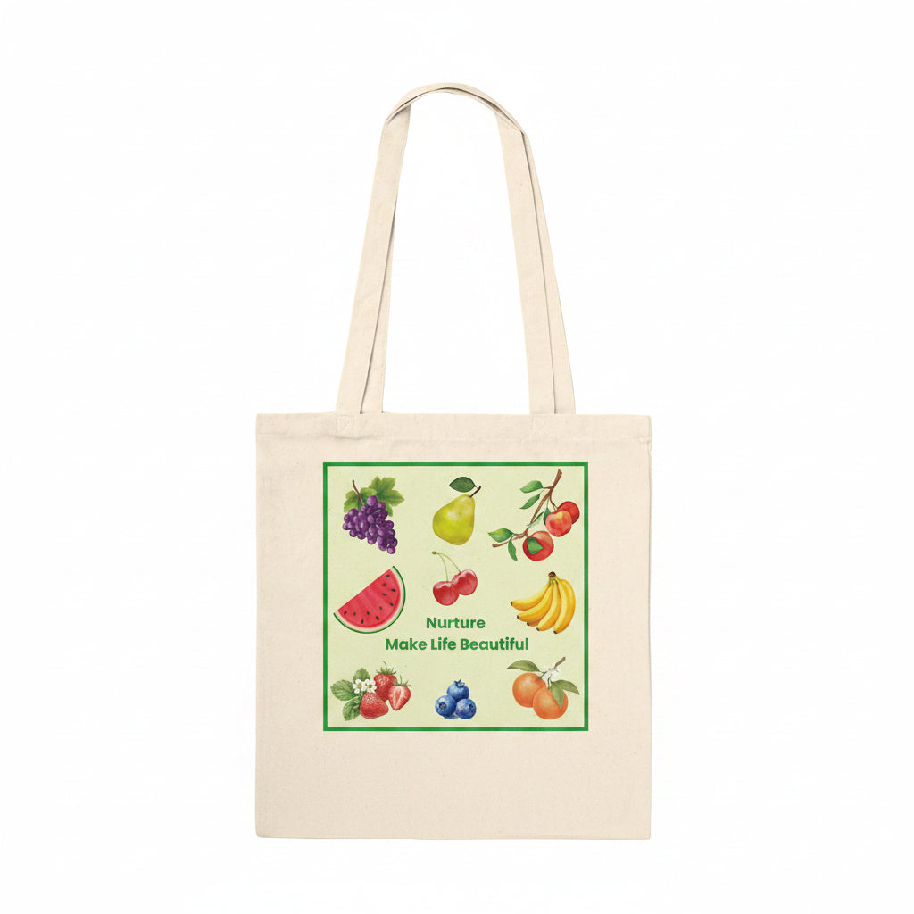 A natural beige canvas tote bag with two shoulder straps, featuring a colorful square graphic print on the front. The graphic shows various fruits (grapes, pear, cherries, watermelon, bananas, blueberries, oranges) with the text 'Nurture Make Life Beautiful' in green.