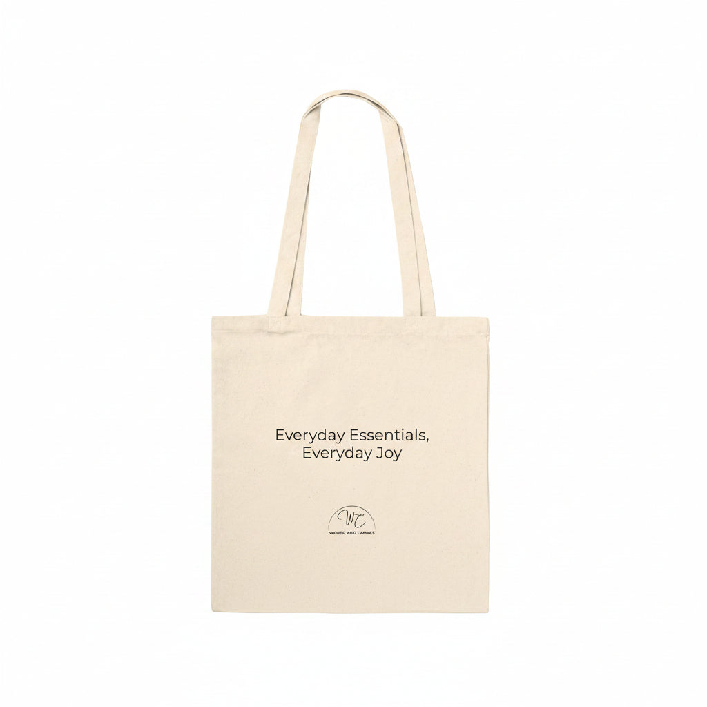 A natural canvas tote bag with two handles, featuring the printed text 'Everyday Essentials, Everyday Joy' and a small circular logo on the front, set against a plain white background.