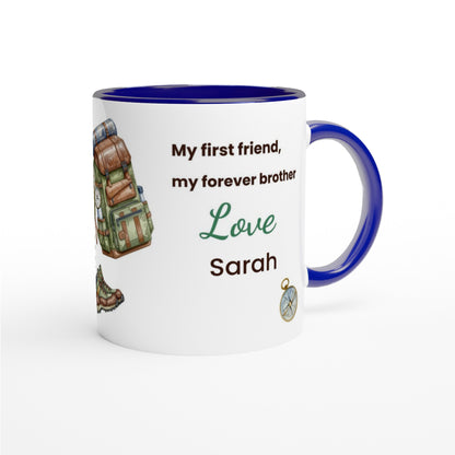 A white ceramic mug with a dark blue interior, handle, and rim, featuring a custom printed design for a brother. The design includes the text 'My first friend, my forever brother Love Sarah' alongside illustrations of a hiking backpack, hiking boots, and a compass.
