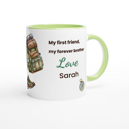 A white ceramic mug with a light green interior and handle, printed with the text 'My first friend, my forever brother Love Sarah' alongside a hiking backpack illustration and a small compass graphic.