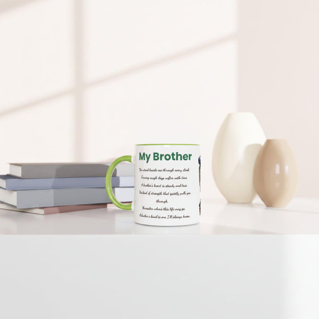 A white ceramic mug with a green handle and green text reading 'My Brother' sits on a white tabletop beside stacked books and two decorative vases in a softly lit interior setting.