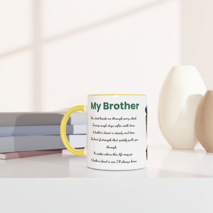 A white ceramic mug with a yellow handle and rim, featuring a printed poem titled 'My Brother' in green and black text. The mug is styled on a white surface next to stacked books, with soft-focus beige vases in the background.