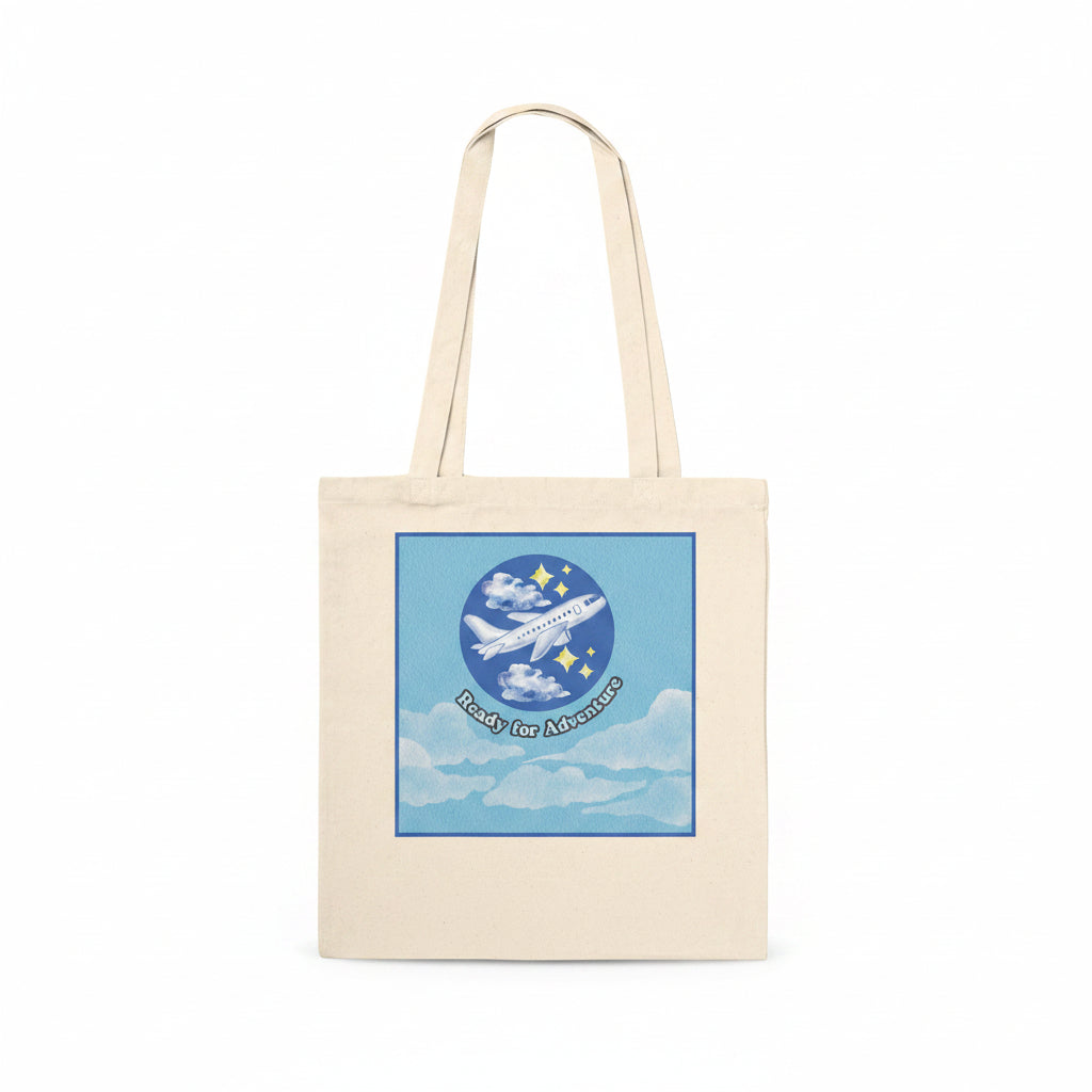 A natural canvas tote bag with a square graphic print on the front. With the text 'Ready for Adventure' below.