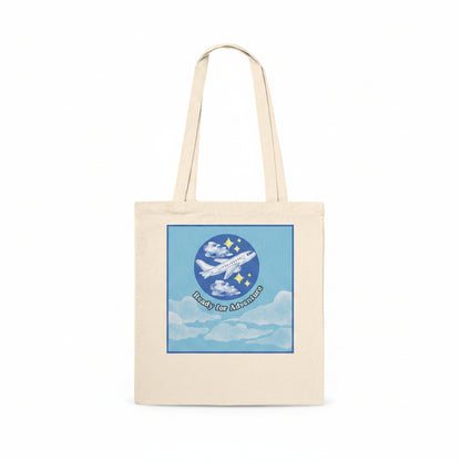 A natural canvas tote bag with a square graphic print on the front. With the text 'Ready for Adventure' below.