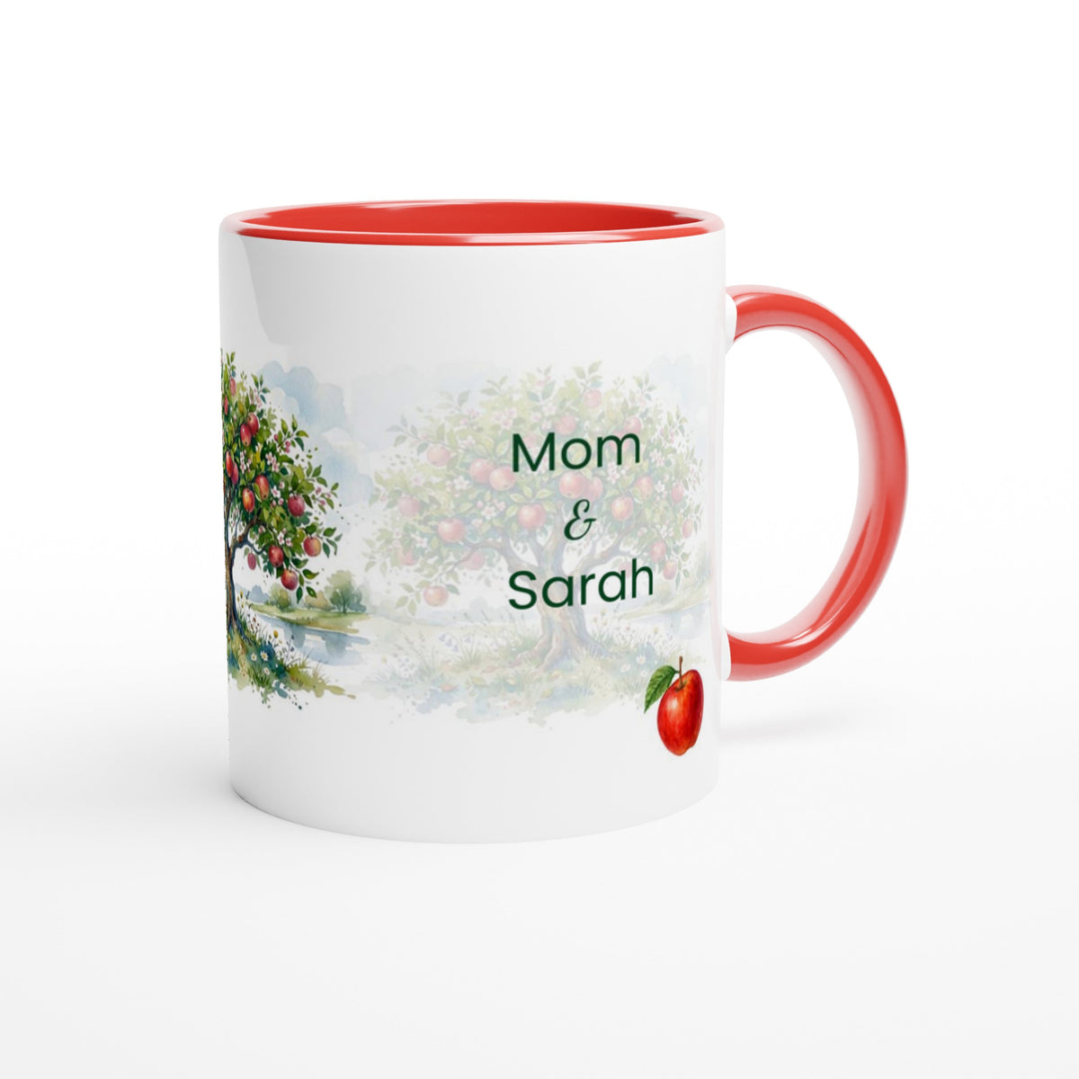 A white ceramic mug with a red interior and red handle, featuring a printed watercolor landscape of an apple tree and the personalized text 