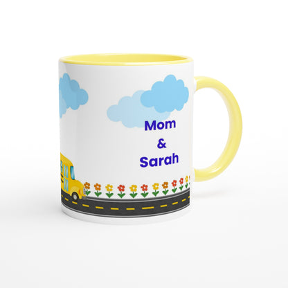 A white ceramic mug with a yellow handle and yellow interior, decorated with a school bus, blue clouds, a flower border, and the text 'Mom & Sarah' in blue, shown on a white background.