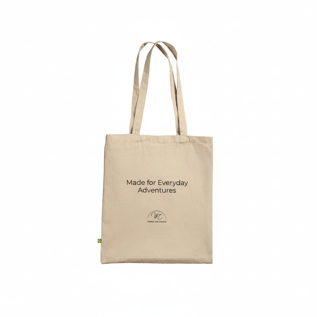 A beige canvas tote bag with black printed text reading 'Made for Everyday Adventures' and a small circular logo near the bottom, shown on a plain white background.