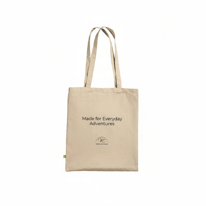A beige canvas tote bag with black printed text reading 'Made for Everyday Adventures' and a small circular logo near the bottom, shown on a plain white background.