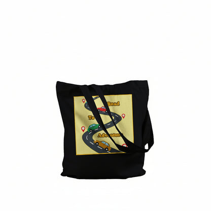 A black canvas tote bag with black shoulder straps, featuring a graphic print on the front. The print shows a winding road with cartoon cars and the words 'Road to Adventure' on a pale yellow background.