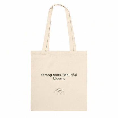 A natural canvas tote bag with black printed text and a small circular logo below