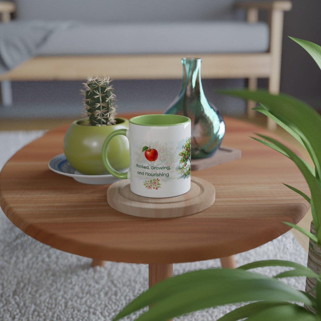 A white ceramic mug with a green interior and handle sits on a round wooden coaster on a wooden coffee table. 
