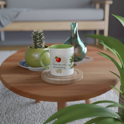 A white ceramic mug with a green interior and handle sits on a round wooden coaster on a wooden coffee table. 