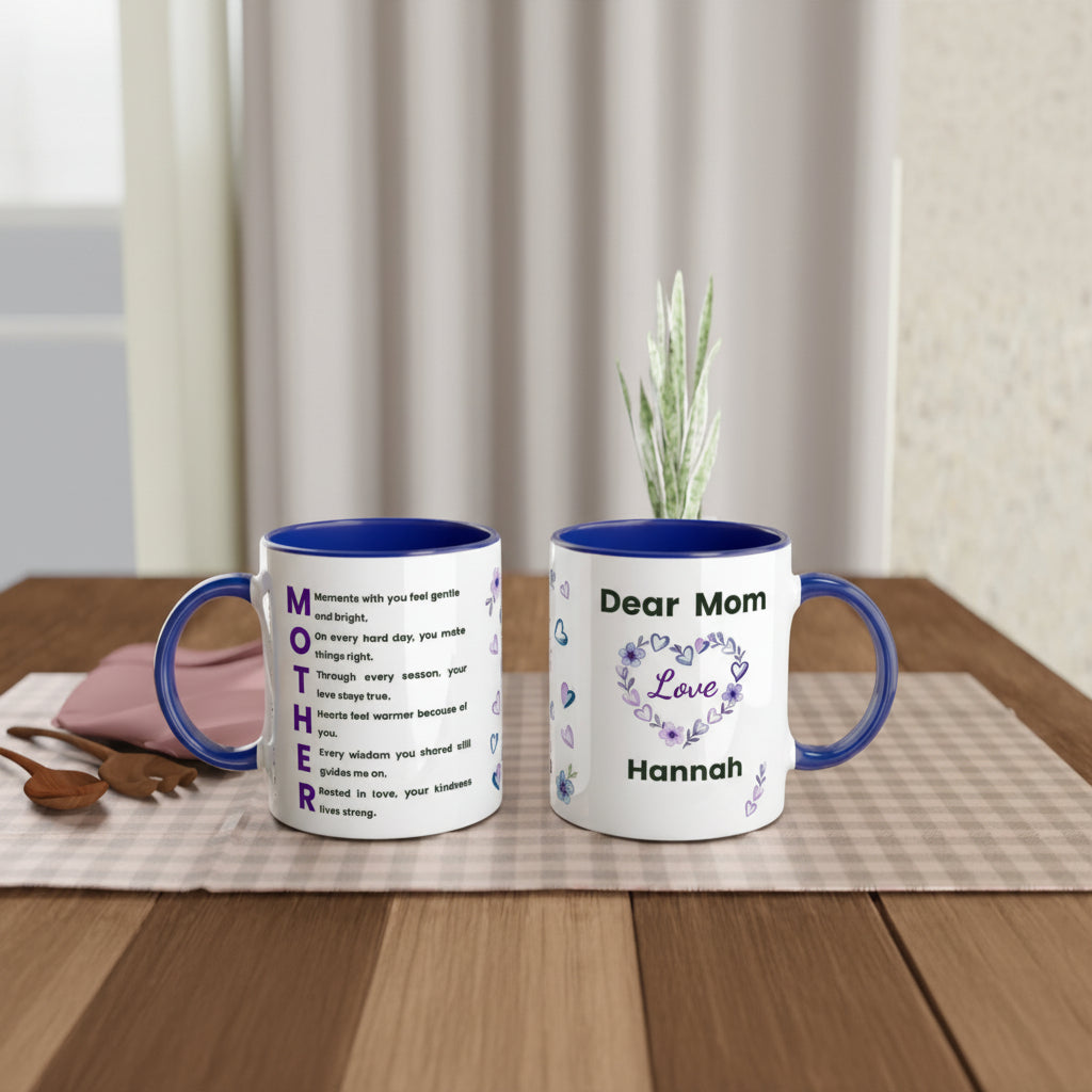 Two personalized ceramic mugs with blue interiors and handles are displayed on a wooden table. One mug shows a white exterior with blue text reading 'MOTHER' and a poem, while the other shows 'Dear Mom Love Hannah' with a floral heart design.