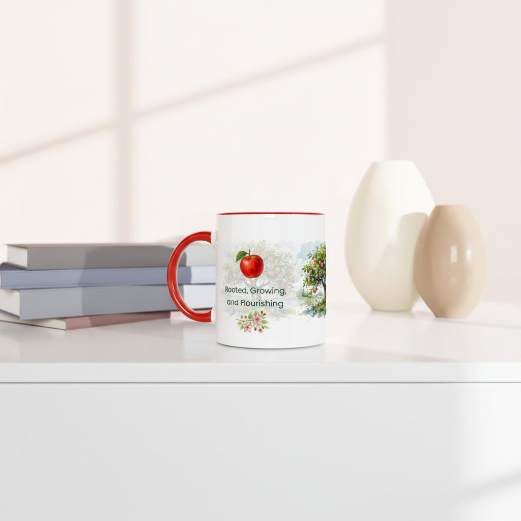 A white ceramic mug with a red handle and red rim sits on a white shelf beside stacked books and two decorative vases.
