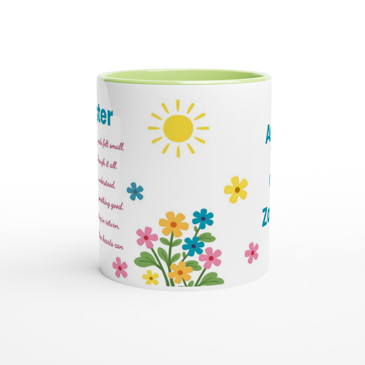 A white ceramic coffee mug with a light green interior, decorated with a yellow sun, colorful flowers, and partial blue and pink text on a white background.