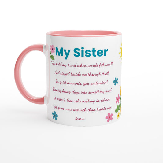 A white ceramic mug with a pink handle and pink interior, featuring the text 'My Sister' in blue and a sentimental poem below in pink, decorated with small colorful flowers.