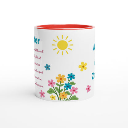 A white ceramic mug with a red interior, decorated with a colorful sun, flowers, and text on a clean white background.