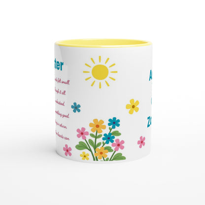 A white ceramic mug with a yellow interior and lid, decorated with colorful spring-themed illustrations including a yellow sun, blue and pink flowers, and green leaves, alongside partial blue text.