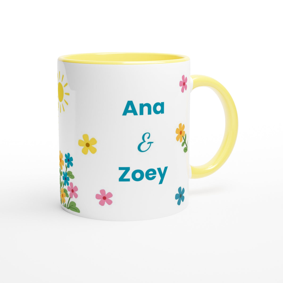 A white ceramic mug with a yellow interior and handle, decorated with colorful flowers and the personalized names 'Ana & Zoey' in teal text.
