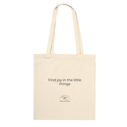 Back of natural coloured tote bag, with logo and quote " Find joy in the little things".