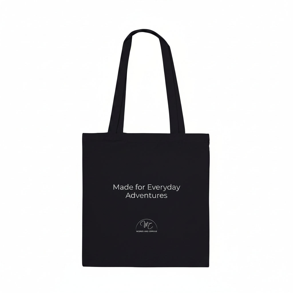 Black tote bag with a small red logo on a white background