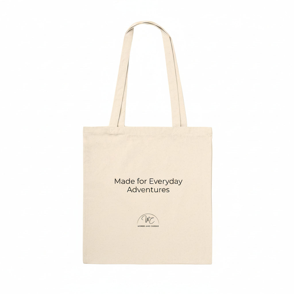 A natural canvas tote bag with black printed text reading 'Made for Everyday Adventures' and a small circular logo near the bottom, shown on a plain white background.