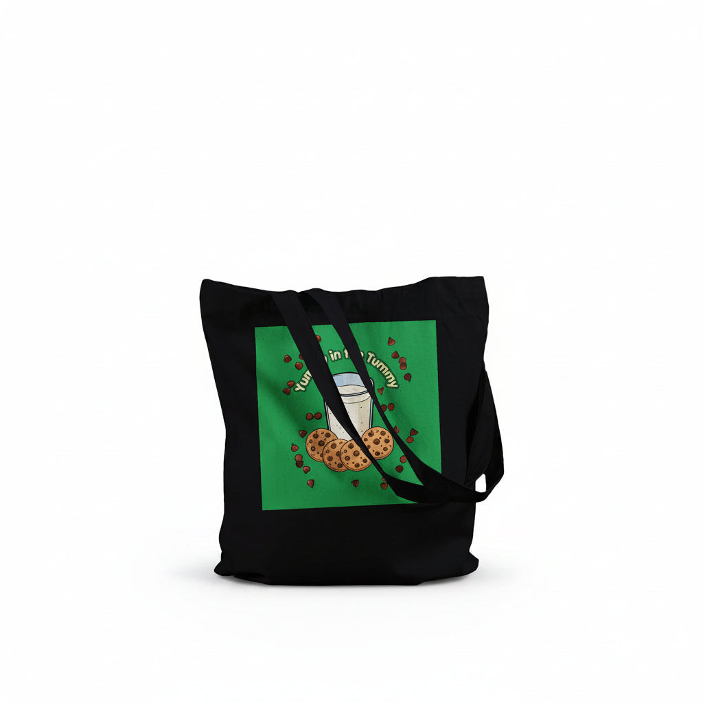A black canvas tote bag with two shoulder straps, featuring a green square graphic on the front with a milk glass and cookies